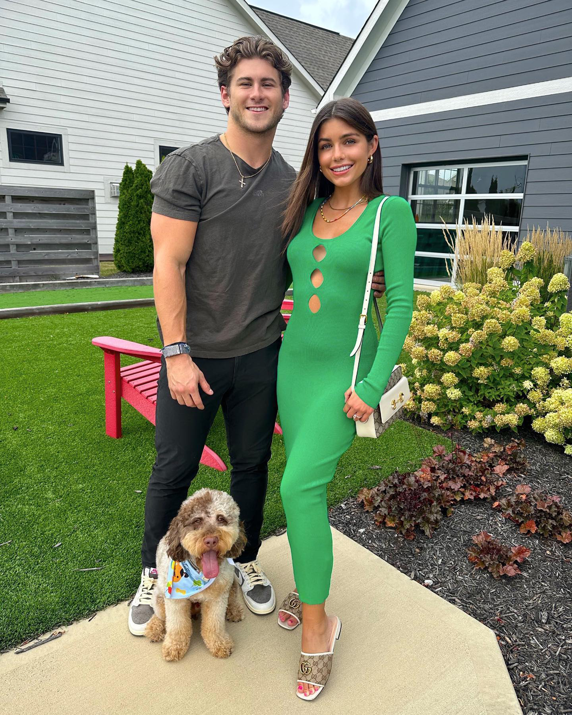 Jake Funk and Hannah Ann Sluss posing with their dog