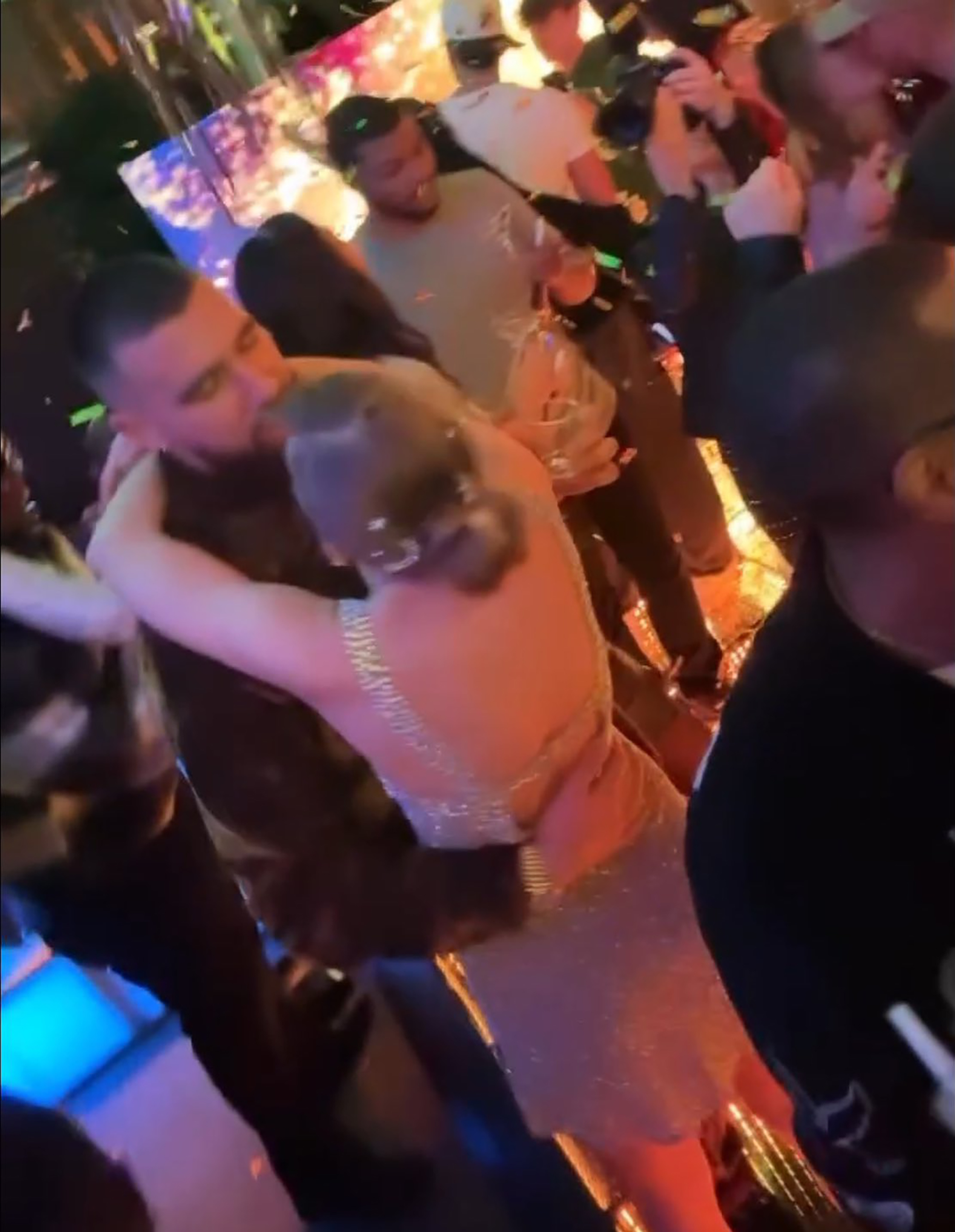 Taylor Swift and Travis Kelce kissing.