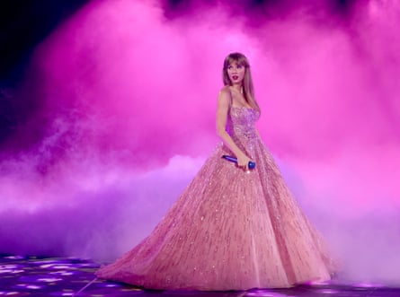 Taylor Swift in a pink gown on stage