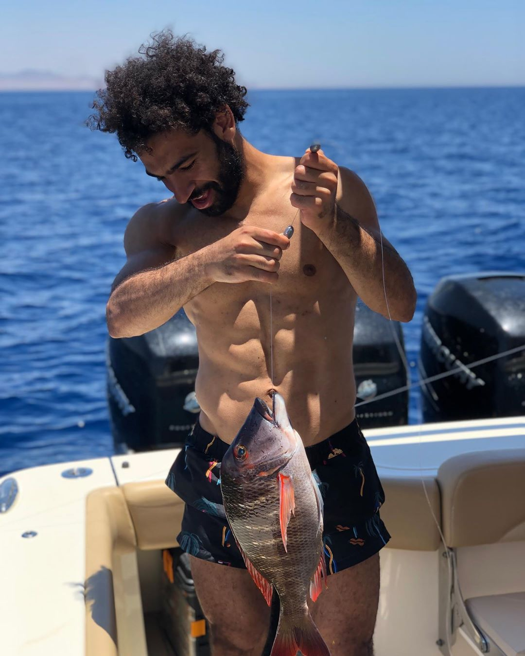 Liverpool's Mo Salah catches another big fish as Egyptian relaxes after  Champions League glory | The Sun