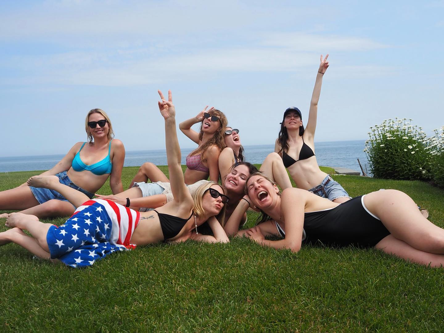Taylor Swift and friends on the grass at her Rhode Island home.