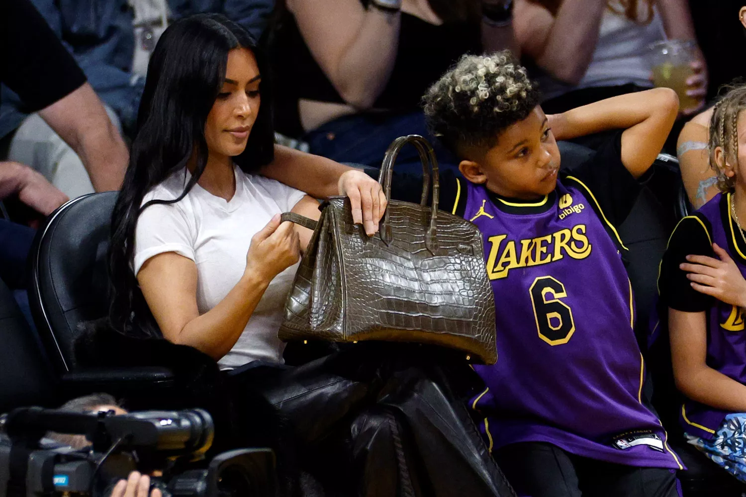 Kim Kardashian and her son Saint West attend a basketball game between the Los Angeles Lakers and Golden State Warriors at Crypto.com Arena on March 16, 2024