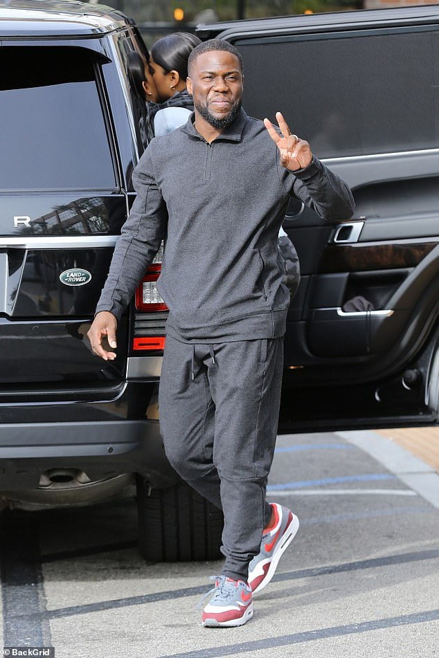 Rosy outlook: Kevin Hart flashed a smile and a peace sign after a family lunch in the Woodland Hills neighborhood of Los Angeles on Sunday 