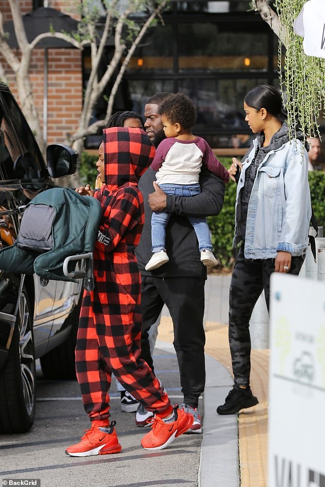 Daddy duties: Hart and his wife Eniko Parrish worked together to get the children in their SUV