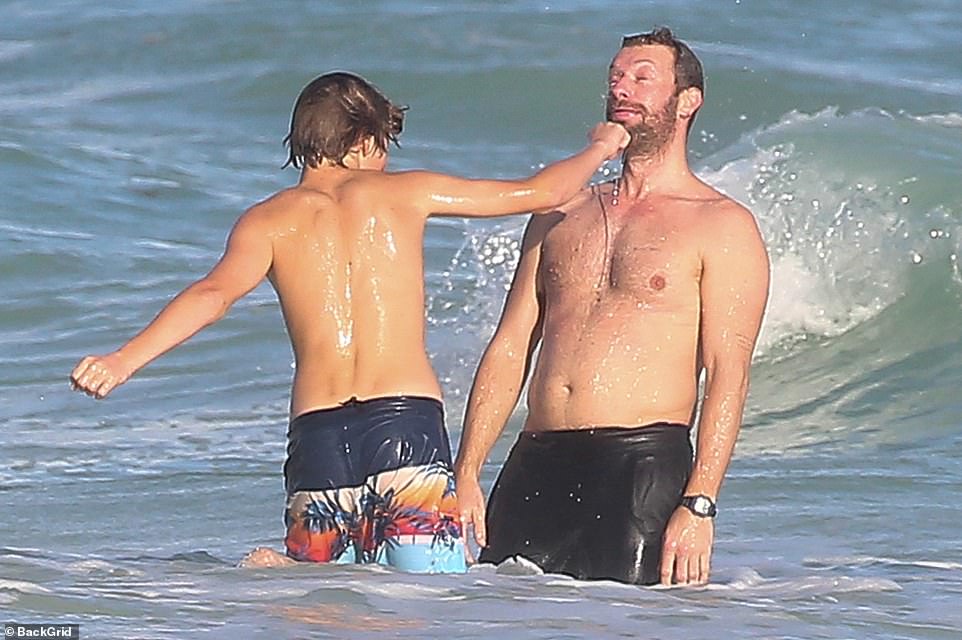 Chris Martin gets a pretend 'punch' to his face by son Moses,15, as they  play fight in Mexico | Daily Mail Online