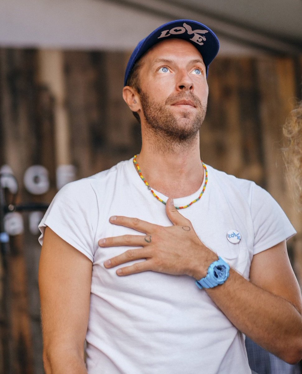 Abhi on X: "Chris Martin wears a love button no matter where he is and what  he's doing and he usually gives it out to people too. Here you can see he's