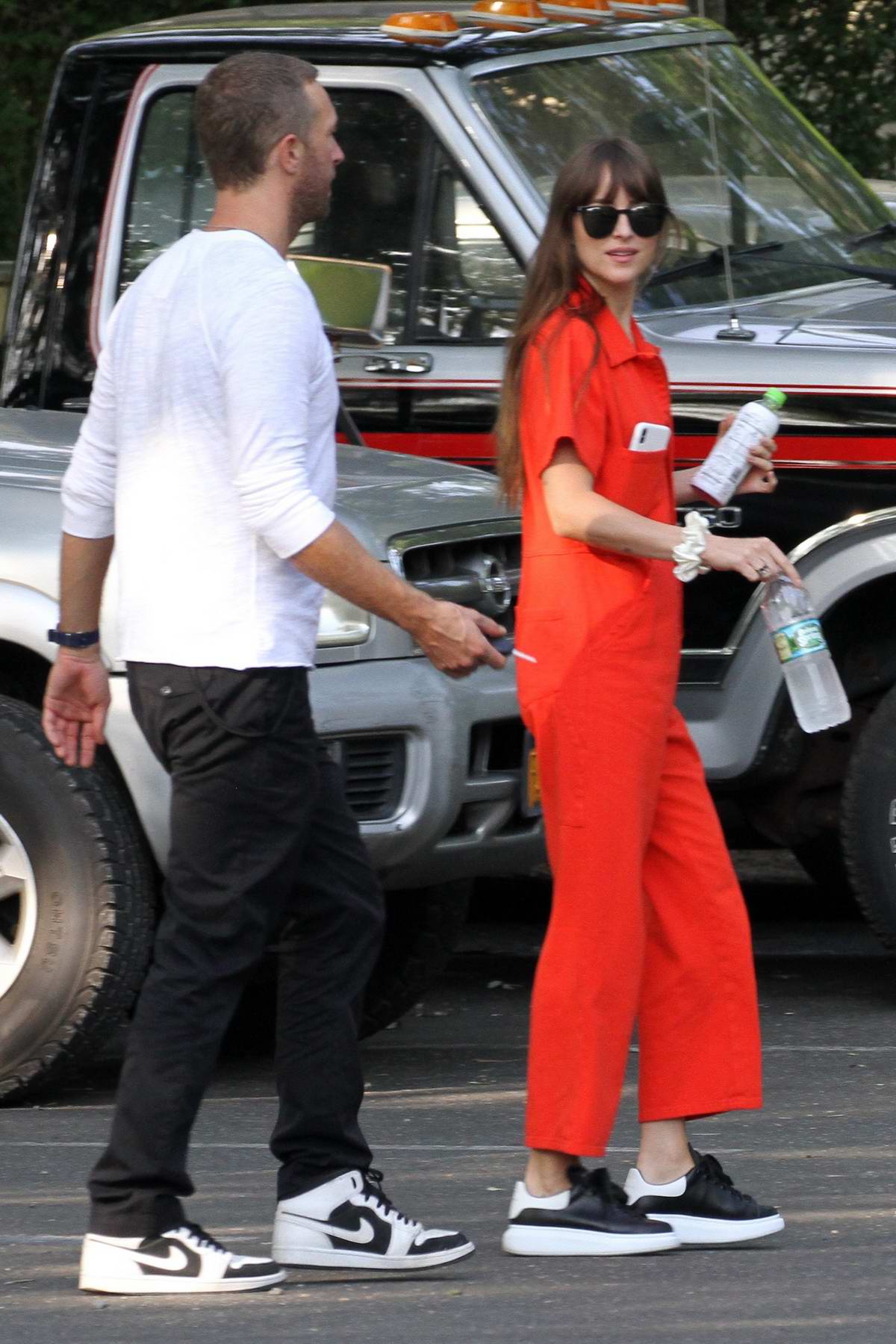 dakota johnson seen wearing an orange jumpsuit while out for lunch with  chris martin in the hampton's, new york-050819_4