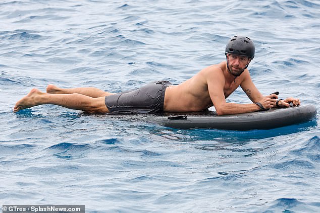 Chris Martin shows off his impressive physique as he enjoys electric surfing  session with son Moses, 17, during trip to Ibiza | Daily Mail Online