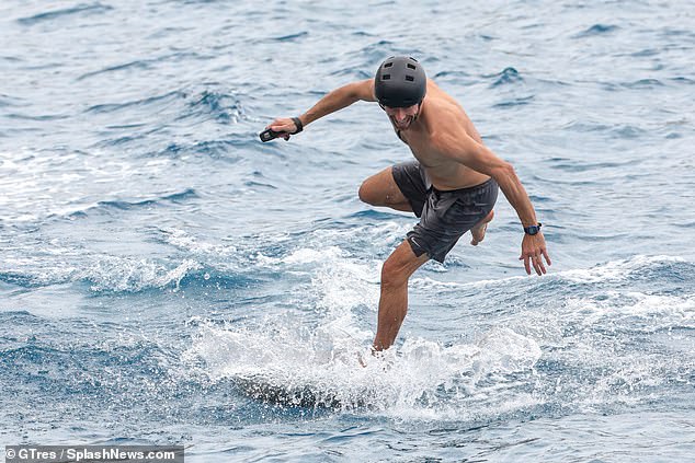 Chris Martin shows off his impressive physique as he enjoys electric surfing  session with son Moses, 17, during trip to Ibiza | Daily Mail Online