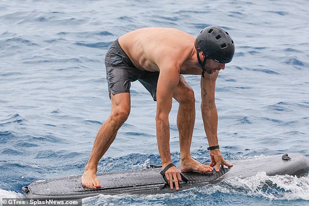 Chris Martin shows off his impressive physique as he enjoys electric surfing  session with son Moses, 17, during trip to Ibiza | Daily Mail Online