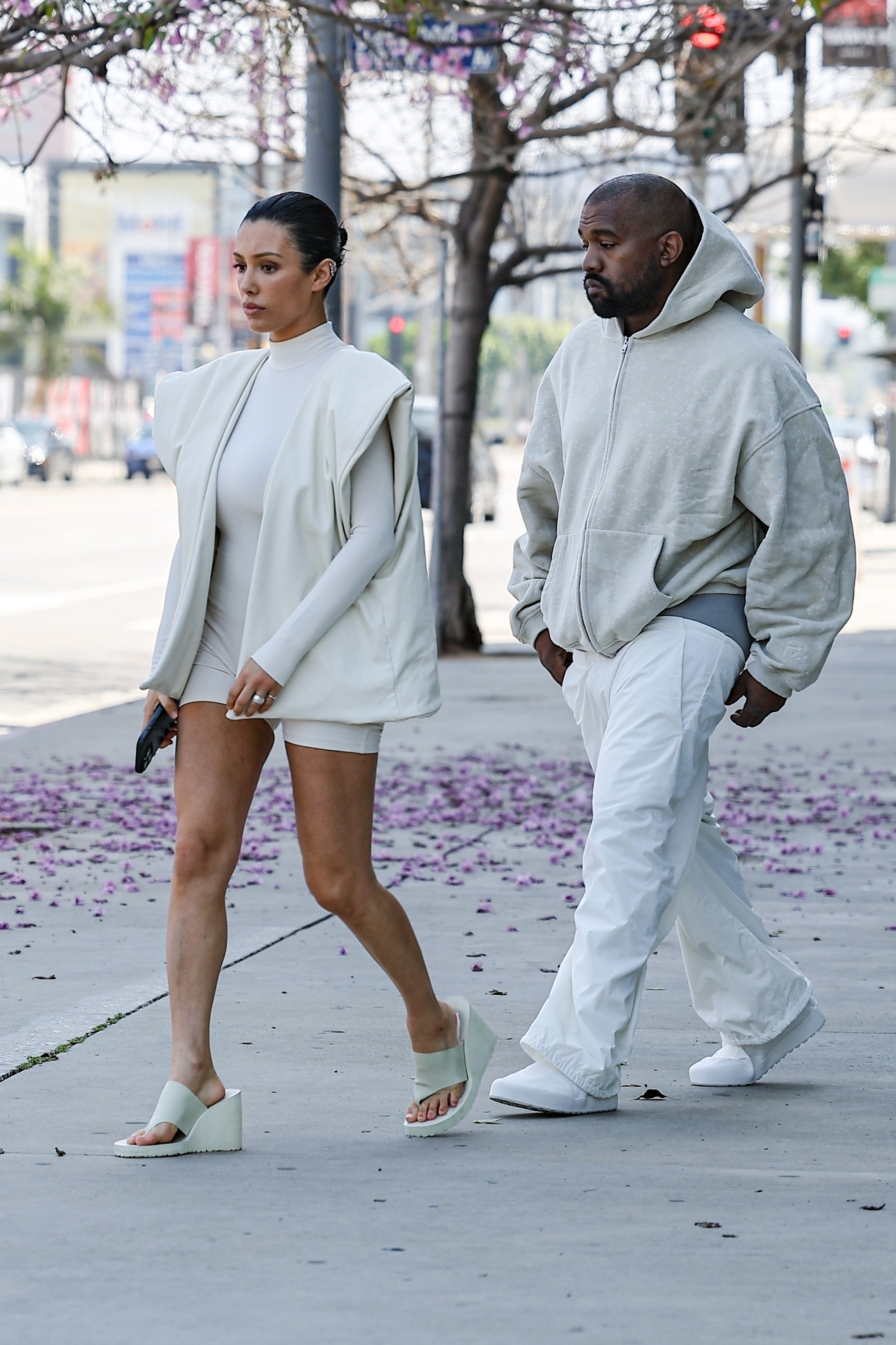 Kanye West stepped out with his wife, who looked distraught, in new photos