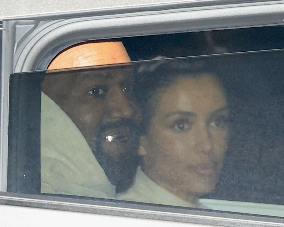 Kanye flashed a rare smile while in the backseat of their car