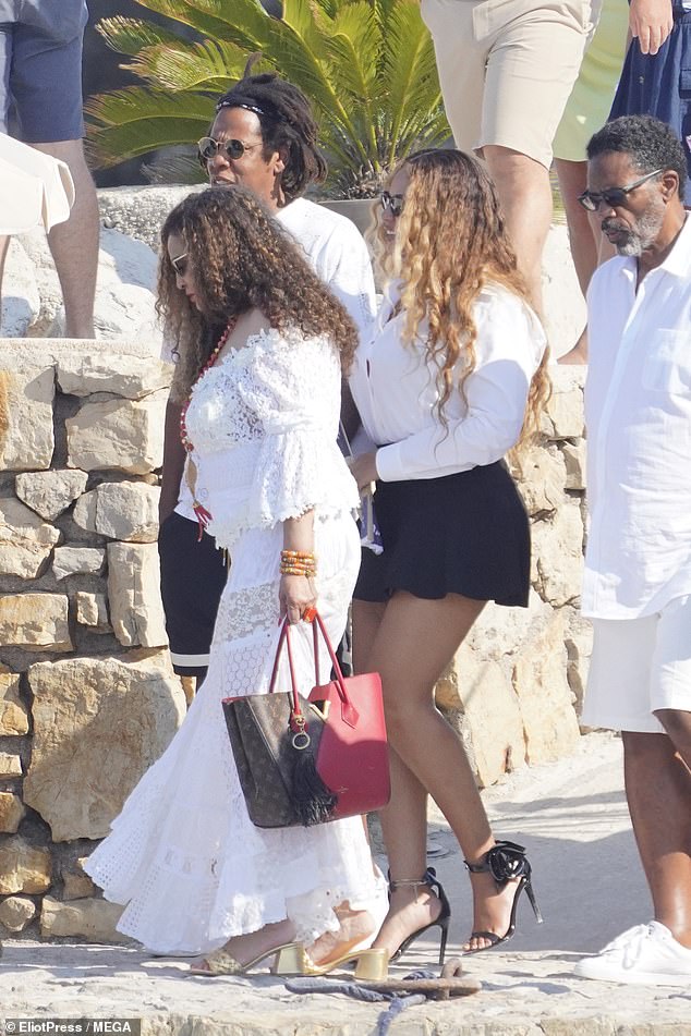 Style: Tina looked elegant in a white off the shoulder dress with a sheer embroidered neckline