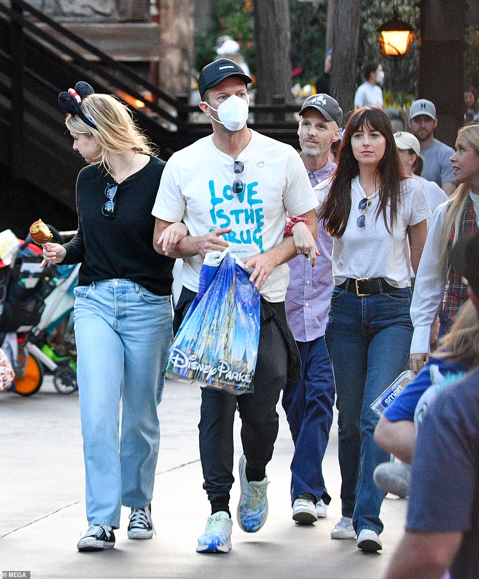 His girls! Chris Martin linked arms with girlfriend Dakota and daughter Apple