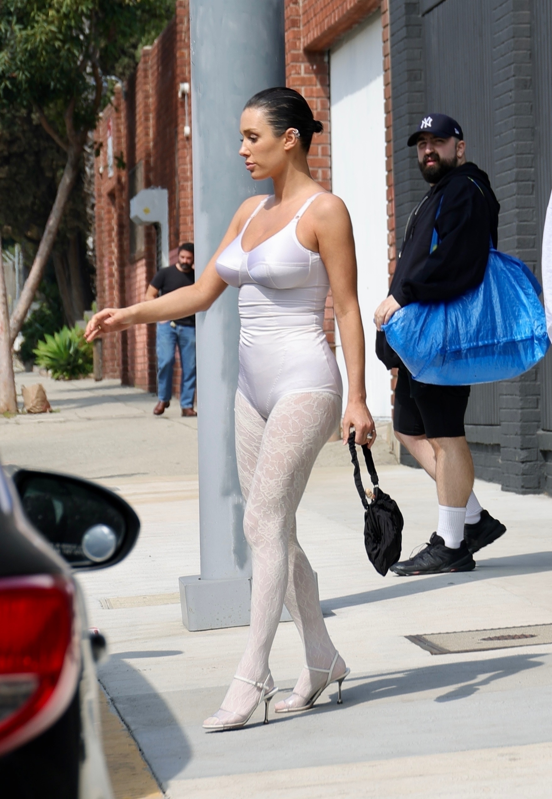 Bianca Censori fails to flash a smile as she wears bodysuit and lace tights  during tense outing with Kanye West in LA | The US Sun