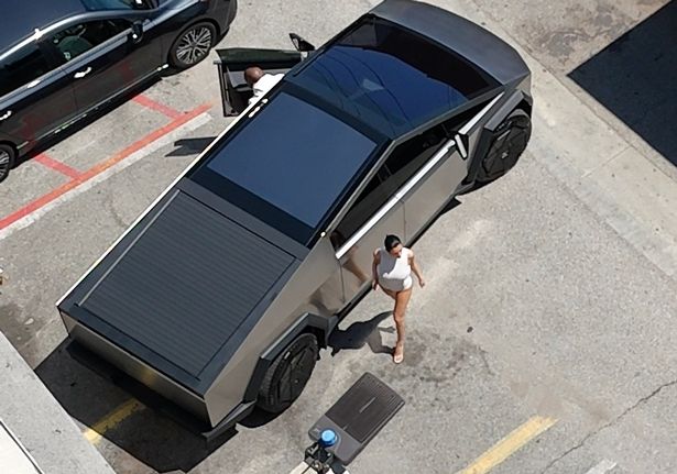 Kanye West and Bianca Censori next to his Cybertruck