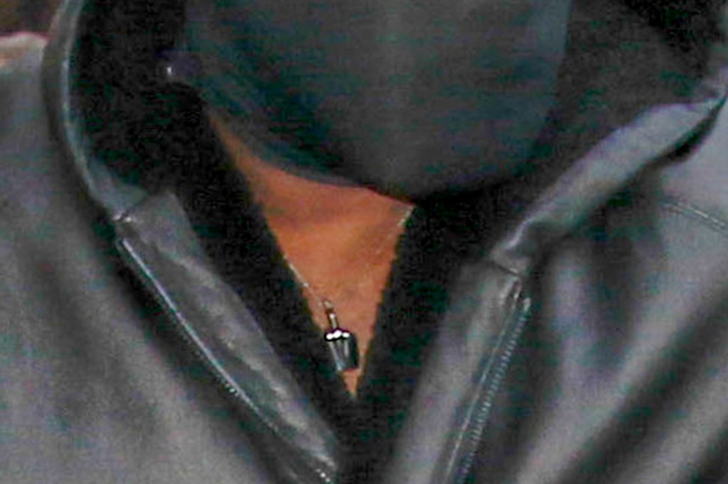 Kanye west wearing a middle finger necklace