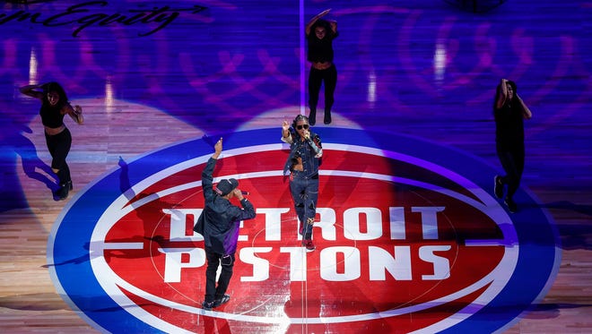 Rapper Dej Loaf, center, performs before the Detroit Pistons' home opener at the Little Caesars Arena in Detroit, Wednesday, October 18, 2017.