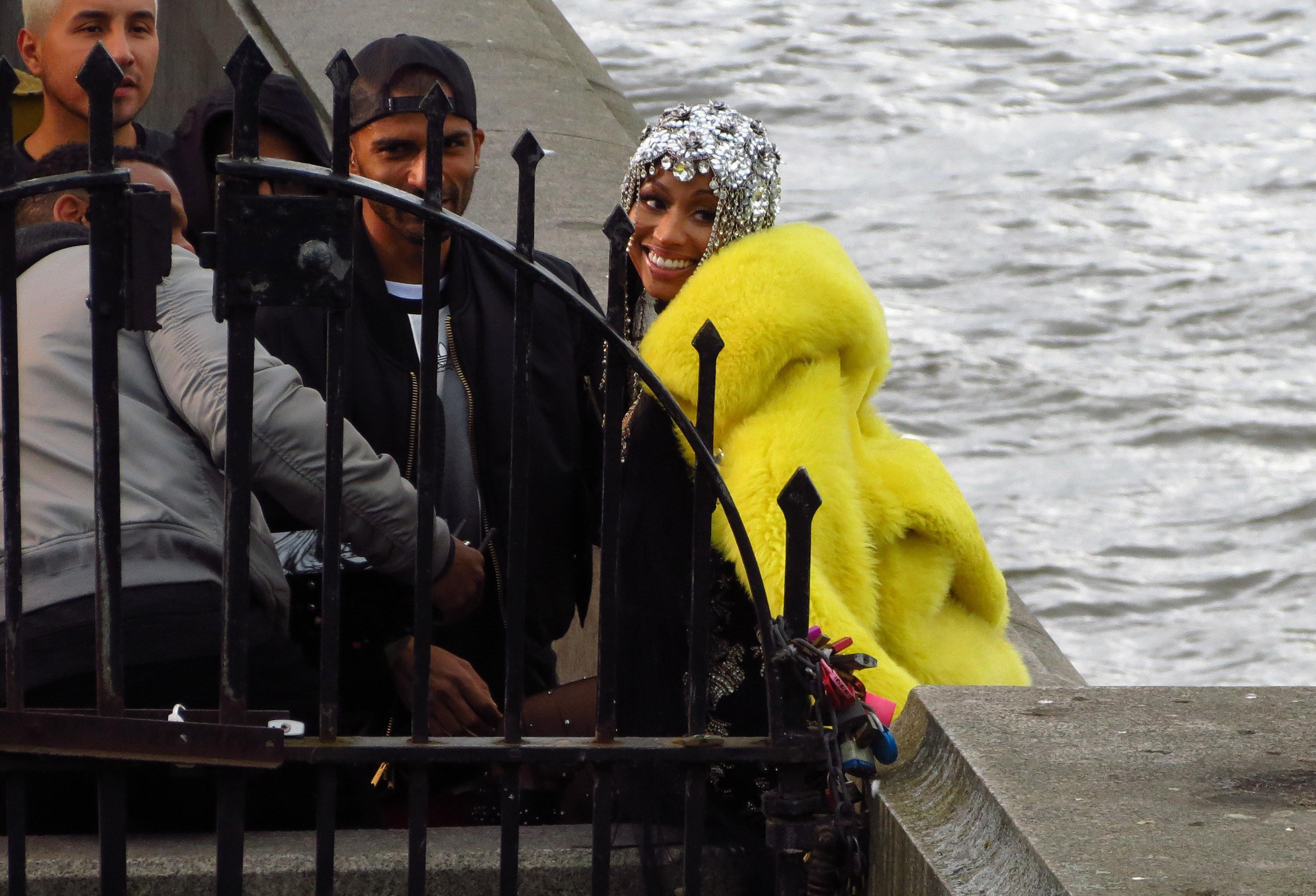  Nicki smiled as she also wore a bright yellow fur coat