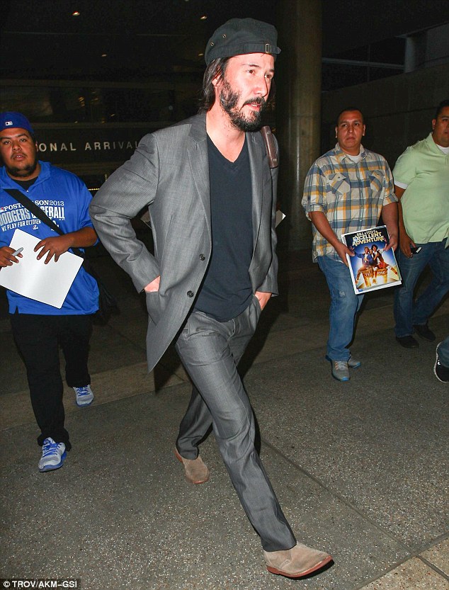 Bearded: The actor sported some facial scruff as he sauntered through the terminal