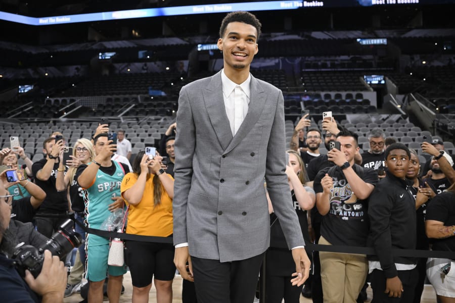 San Antonio Spurs' Victor Wembanyama, the No. 1 draft pick, greets fans before an NBA basketball press conference, Saturday, June 24, 2023, at the AT&T Center in San Antonio. (AP Photo/Darren Abate)