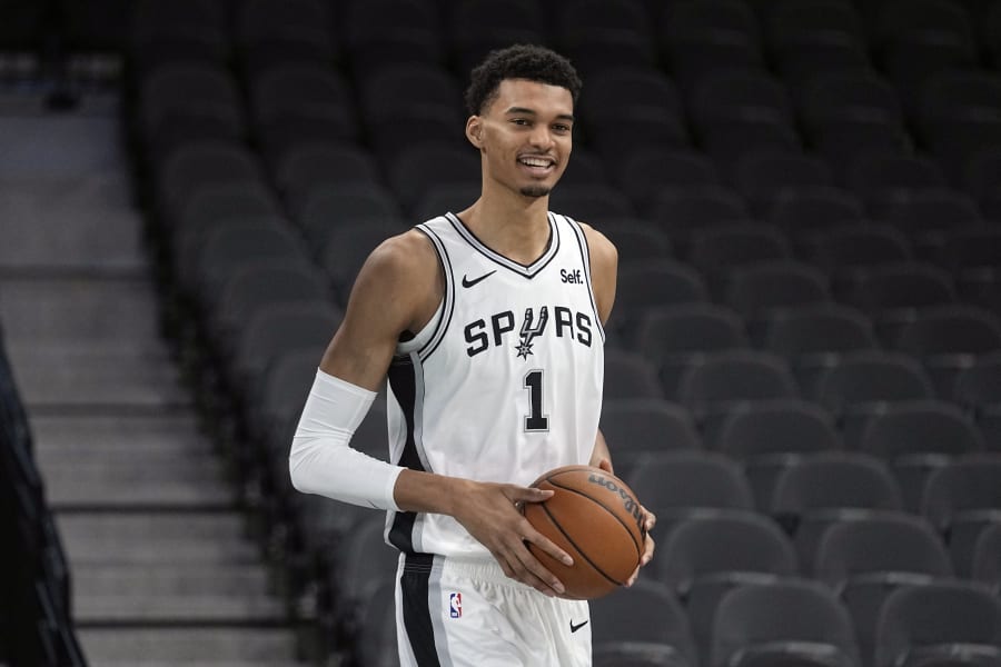 San Antonio Spurs' Victor Wembanyama, the No. 1 draft pick, handles a ball during an NBA basketball press conference, Saturday, June 24, 2023, at the AT&T Center in San Antonio. (AP Photo/Eric Gay)