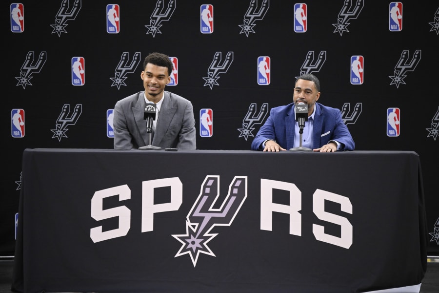 San Antonio Spurs' Victor Wembanyama, left, the No. 1 draft pick, and Spurs general manager Brian Wright, speak during an NBA basketball press conference, Saturday, June 24, 2023, at the AT&T Center in San Antonio. (AP Photo/Darren Abate)