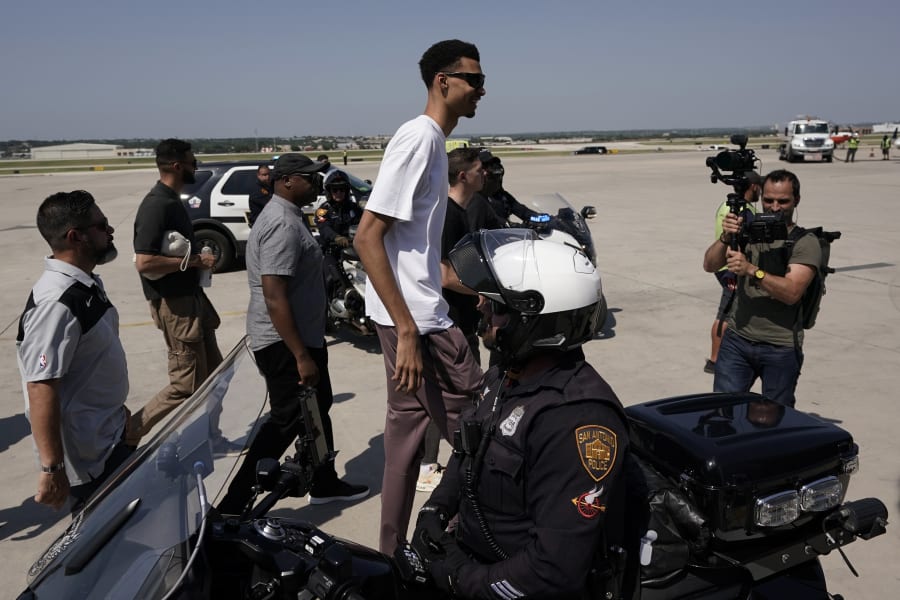 San Antonio Spurs NBA basketball first-round draft pick Victor Wembanyama, center, arrives in San Antonio, Friday, June 23, 2023. (AP Photo/Eric Gay)