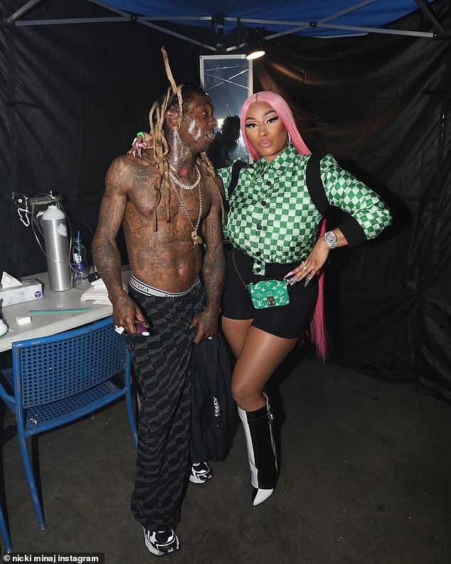 Pals: She showed off her perfect pout while wrapping her arm around a shirtless and tattoo-covered Lil Wayne