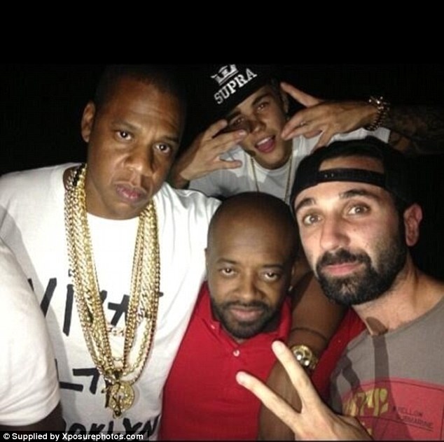 Partying it up: Jay Z and Jermaine Dupre mug for the camera as Justin Bieber flashes gang signs behind them, in Miami, Florida, on Friday