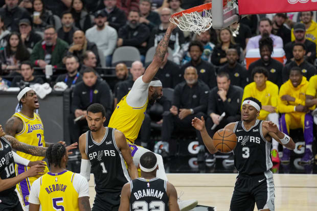 Dec 13, 2023; San Antonio, Texas, USA;  Los Angeles Lakers forward Anthony Davis (3) dunks in front of San Antonio Spurs center Victor Wembanyama (1) in the first half at the Frost Bank Center. 