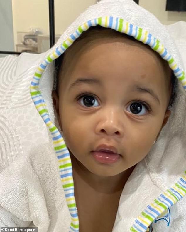 Adorable: She showed the nine-month-old cutie rocking a white robe after presumably getting out of a bath