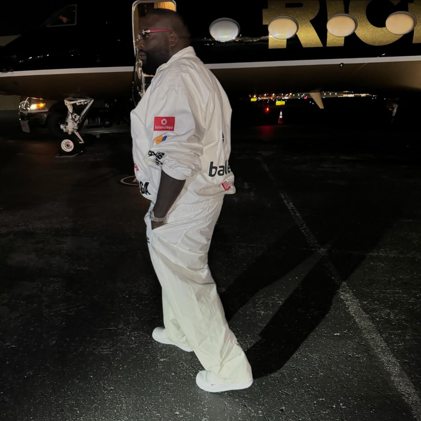 Photo by Rick Ross on June 15, 2024. May be an image of 1 person, standing, aircraft and sweatsuit.