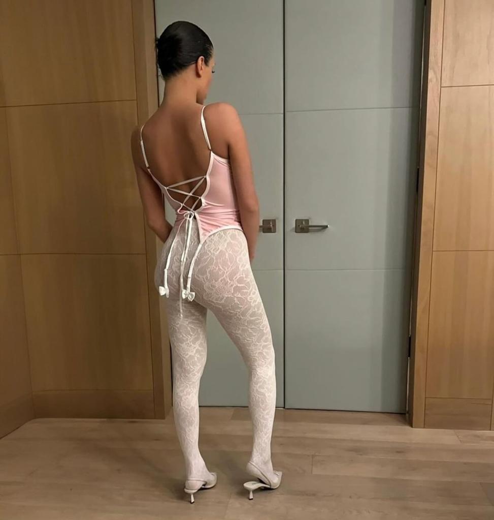 Bianca Censori sports tank top and lace tights for Kanye West 'Vultures'  event with Kim Kardashian