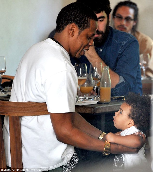 Pick me up, Daddy: Jay-Z happily scooped Blue onto his lap when she came bounding over