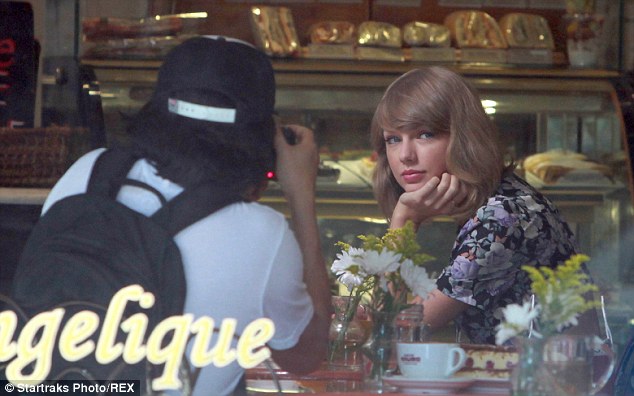 Say cheese: Taylor appeared to be in the middle of a photo shoot inside a New York cafe