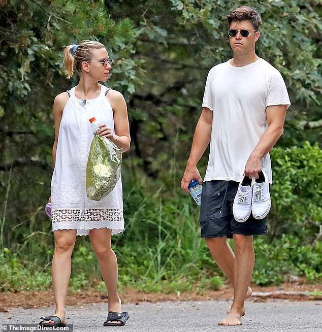 Relaxed style: Colin was dressed in a similarly laid-back fashion, wearing a plain white T-shirt and a pair of charcoal swim trunks