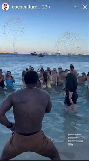 Kevin kept the party going on the beach as he danced with his feet in the water while joined by his friends