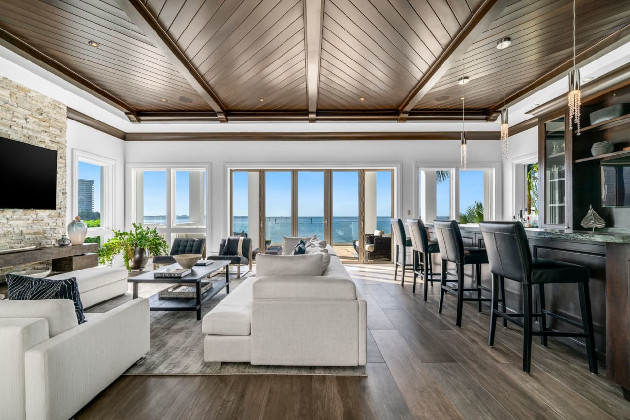 The living room is made for entertaining: It has a bar, a fireplace and astounding water views.