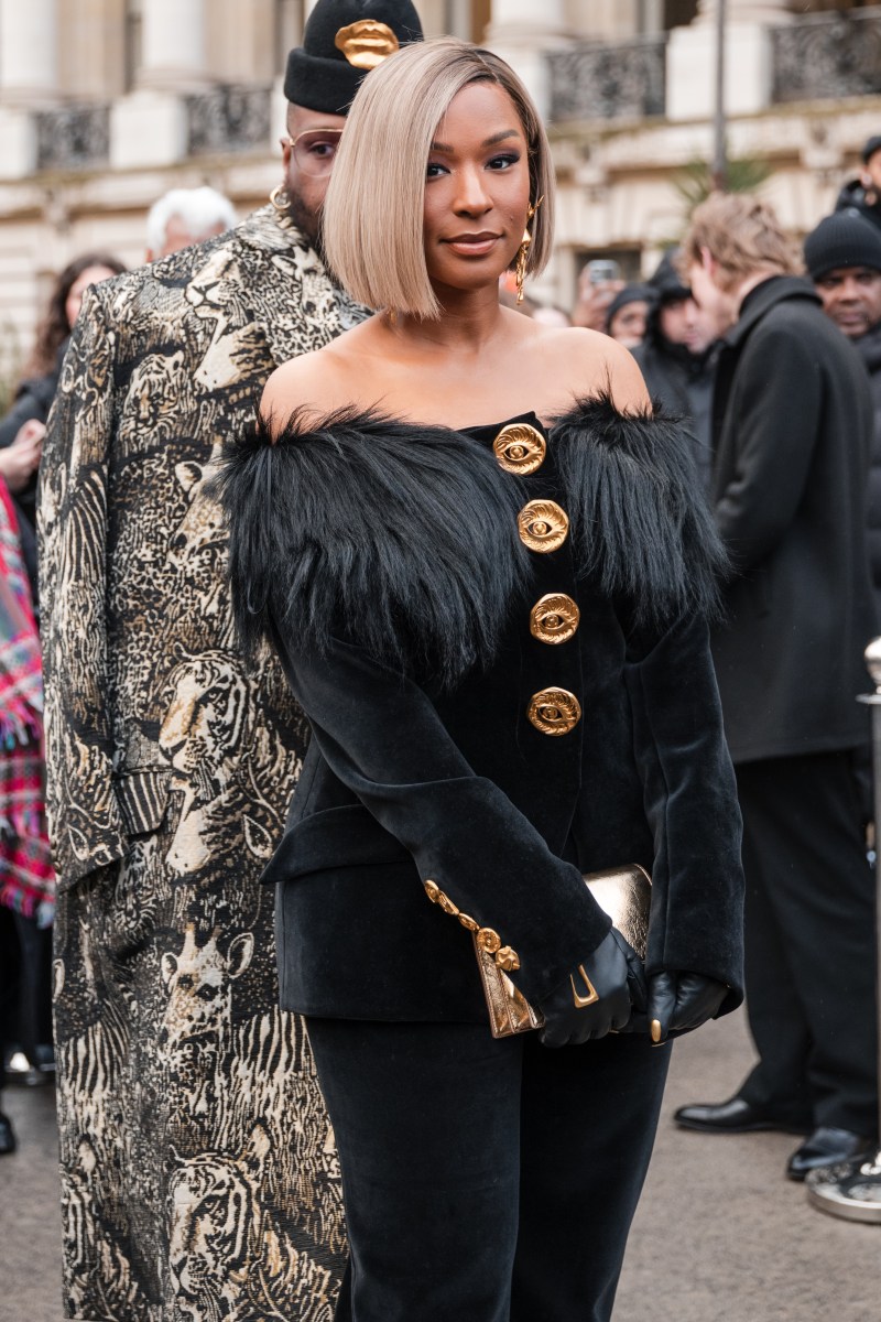 Savannah James style, Savannah James fashion, Savannah James wears black velvet Schiaparelli top with gold buttons and fur details, gold bag, gold earrings, outside Schiaparelli, during the Haute Couture Spring/Summer 2024 as part of Paris Fashion Week on January 22, 2024 in Paris, France. (Photo by Claudio Lavenia/Getty Images)