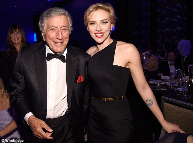 Having a blast: Scarlett also posed with Tony, who looked sharp in a black blazer, trousers and bow tie with a white collared button up shirt