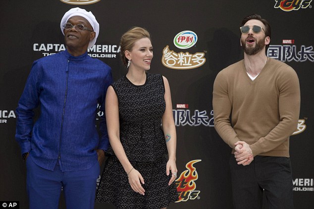 I am the Captain now: Scarlett poses with co-stars Samuel Jackson and Chris Evans at a Captain Amierica: The Winter Soldier publicity event