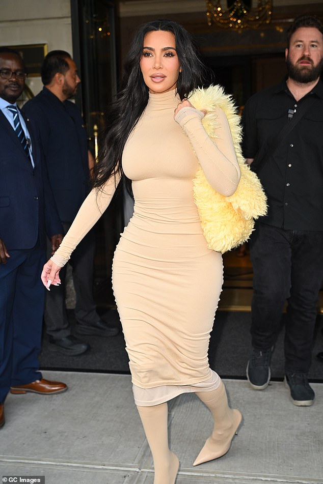 The 43-year-old billionaire wore a snug-fitting beige dress