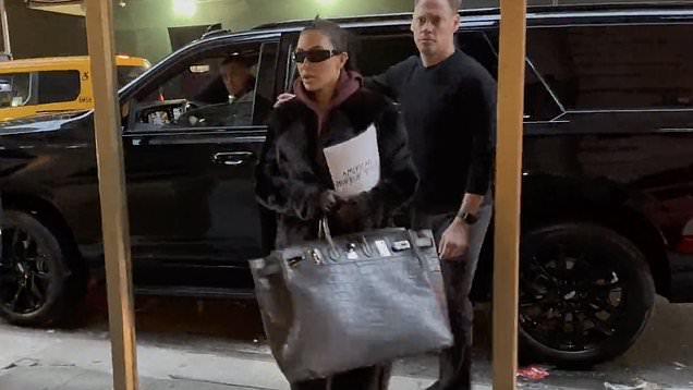 Kim Kardashian swings her MASSIVE $110K Hermes Birkin bag and swathes  herself in red fur coat as she arrives at American Horror Story: Delicate  set | Daily Mail Online