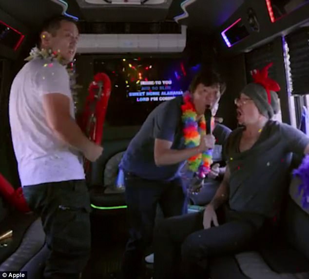 Sing along: Ken rounded up the band inside a party bus for even more karaoke fun 