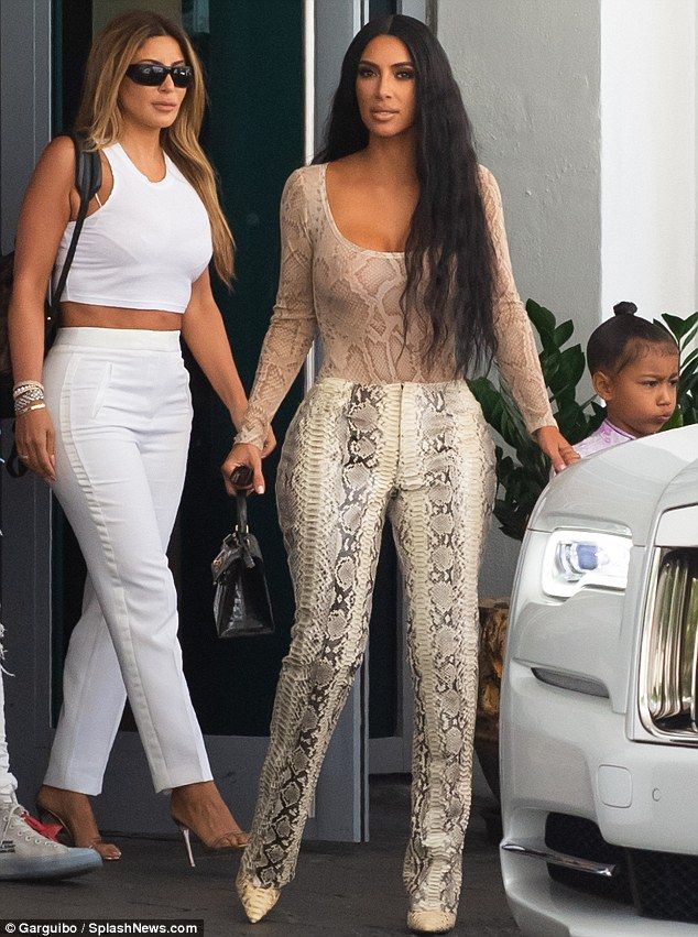 Kim Kardashian sizzles in snakeskin ensemble while out with North