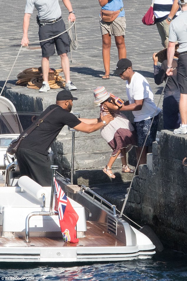 Precious cargo: Doting dad Jay and a pal helped Blue Ivy onto a boat 