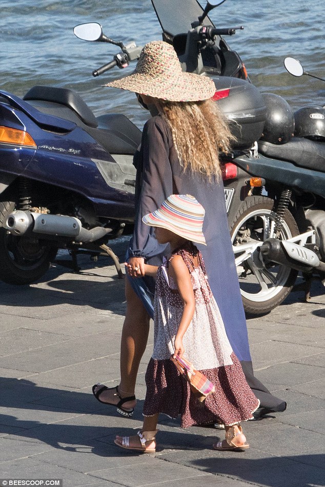 Mini me: Beyonce kept close to her daughter all day, holding her hand in the sunshine 